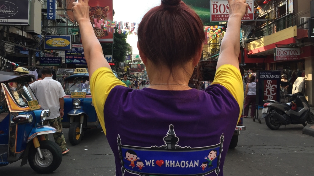 Yada Pornetrumpa on Khaosan Road wearing a 'We Love Khaosan' t-shirt [Adam Bemma/Al Jazeera]