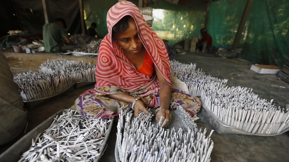 An Indian worker makes firecrackers for the upcoming Hindu festival Diwali at a factory on the outskirts of Ahmadabad, India [Ajit Solanki/AP Photo]