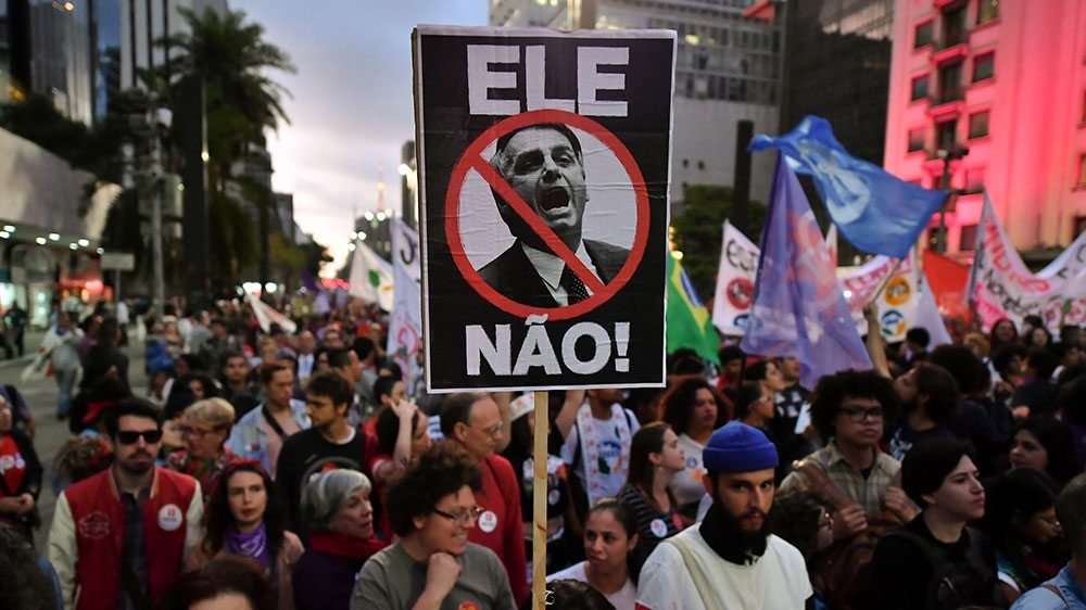 Demonstrators take part in a protest against Brazilian right-wing presidential candidate Jair Bolsonaro in Sao Paulo, Brazil [Nelson Almedia/AFP] 
