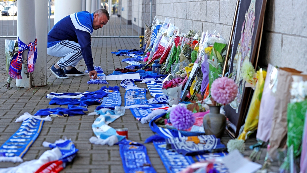 Fans have been laying flowers and football scarves to show their support [Peter Nicholls/Reuters]