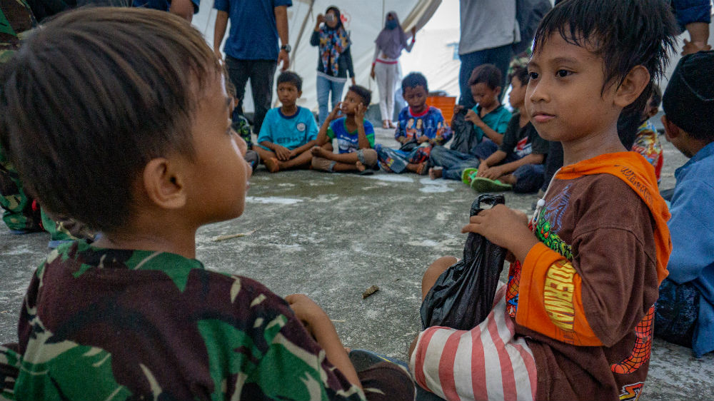 Two Indonesian boys at an event to help children who survived the earthquake and tsunami in Central Sulawesi [Ian Morse/Al Jazeera]