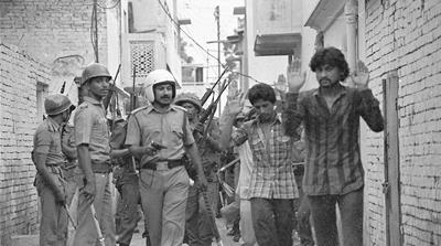 Indian security forces round up Muslim men in Hashimpura on May 22, 1987. Forty-two were later killed that day [Praveen Jain]