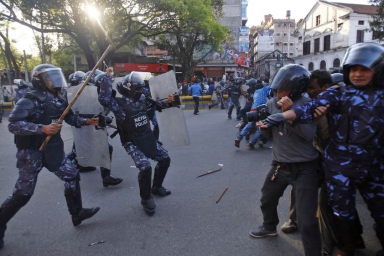 Nepalese policemen charge at members of a splinter faction of the Unified Communist Party of Nepal Maoist during a protest in Katmandu, Nepal, Saturday, March 16, 2013. Police in Nepal''s capital have