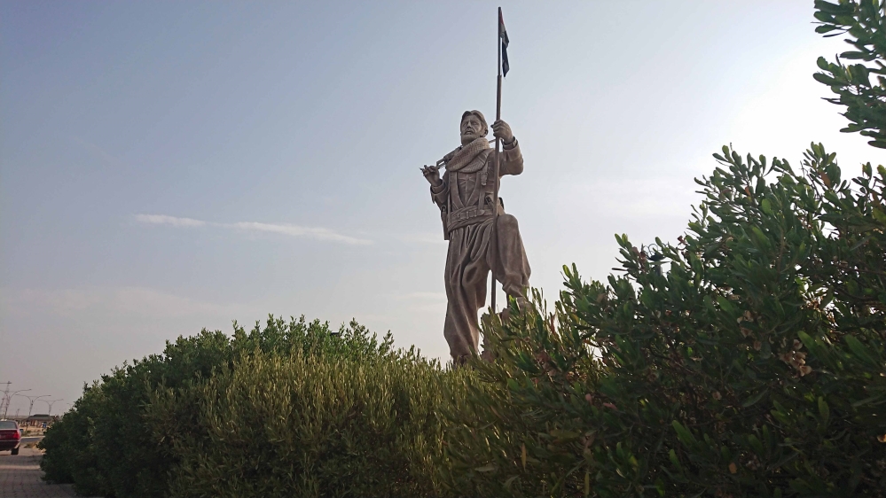 The statue of a Peshmerga fighter was erected in 2017 at the entrance of Kirkuk [Mariya Petkova/Al Jazeera] 