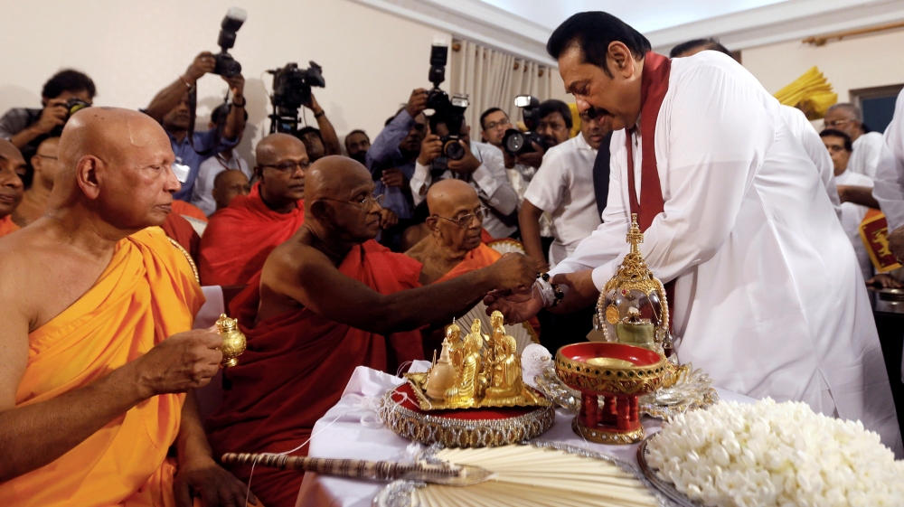 Mahinda Rajapaksa (right) assumed duties of the prime minister's office [Dinuka Liyanawatte/ Reuters]