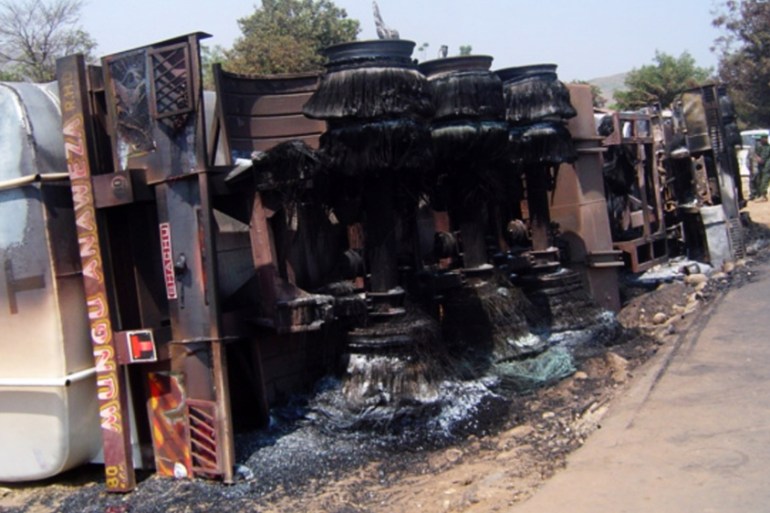 The charred remains of a oil tanker lie on the street of Sange
