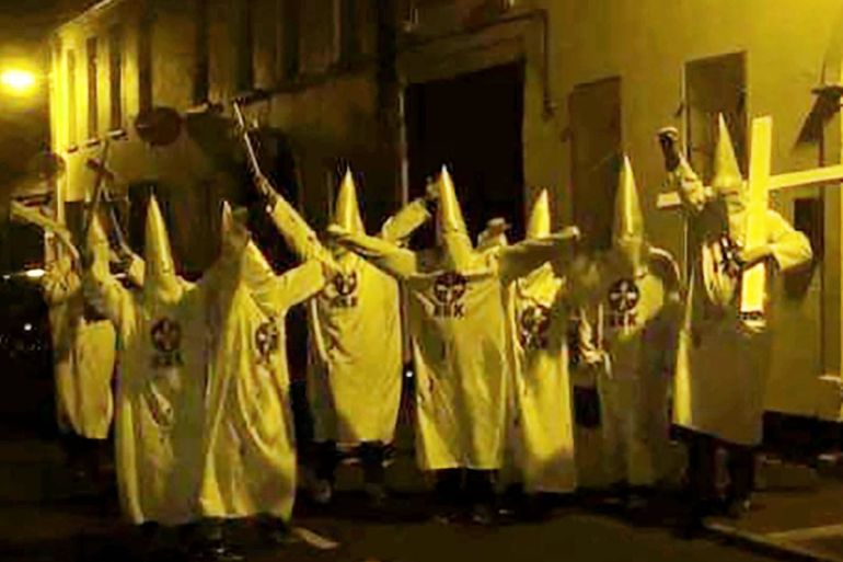 DO NOT USE - Gang dressed as Ku Klux Klan outside a mosque in Newtownards, County Down at the weekend. Recently the same Islamic centre in Newtownards, Northern Ireland came under attack after a pig’s
