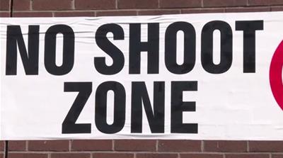 With property owner consent, urban non-violence advocate Tyree Colion places 'No Shoot Zone' banners on buildings and storefronts [Courtesy: Tyree Colion]