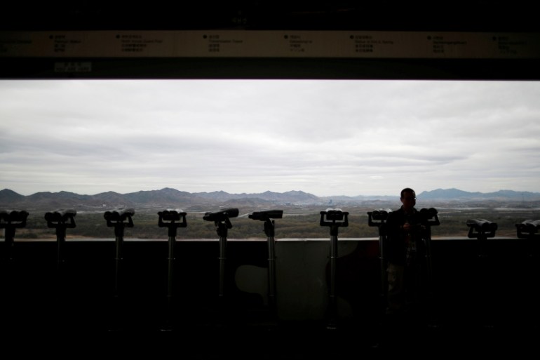 A man stands near binoculars as he tries to see North Korea''s propaganda village of Gijungdong at the Dora observatory near the demilitarised zone separating the two Koreas, in Paju