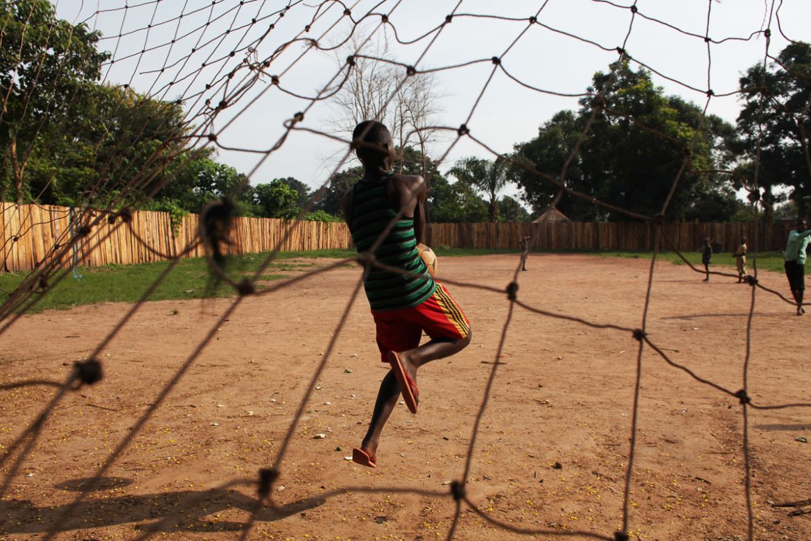 A 16 years old boy who was a bodyguard in the opposition group SSNLM (South Sudan National Liberation Movement) is playing football outside the transit center ran in Yambio run by World Vision and UNI