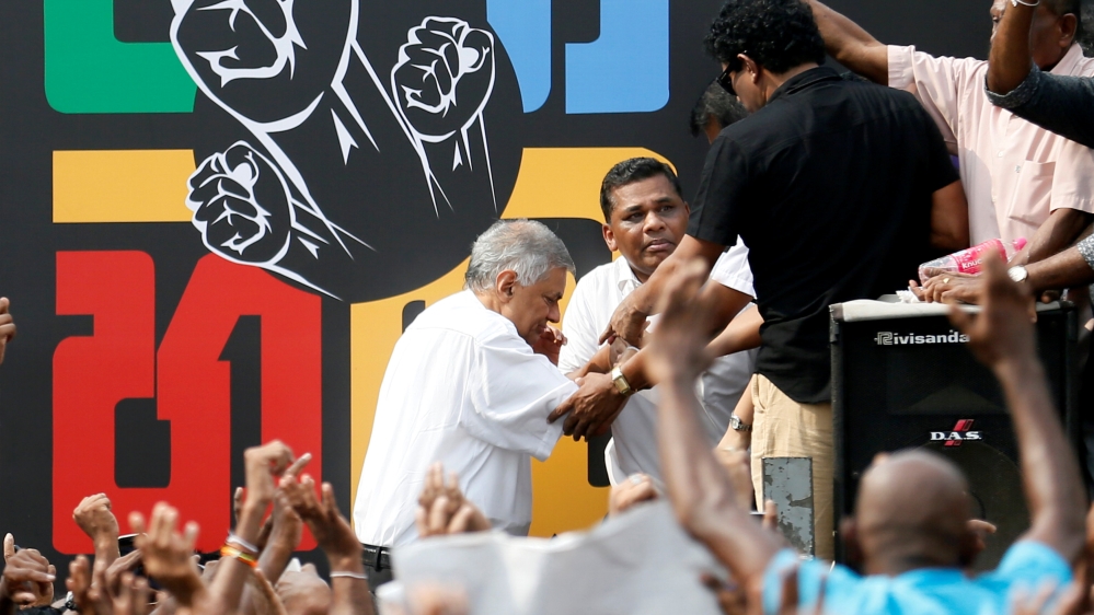 Wickremesinghe arrives at the protest against his removal near the PM's official residence in Colombo [Dinuka Liyanawatte/Reuters]