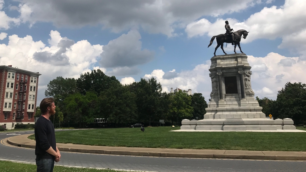 James Gannon with the statue of General Robert E Lee, in Richmond, Virginia [Al Jazeera]