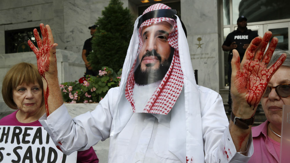 A protester wears a mask of Saudi Arabia's Crown Prince Mohammed bin Salman outside the Saudi embassy in Washington, DC [Jacquelyn Martin/AP]