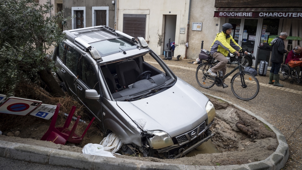 A man rides past a damaged car in the town of Villegailhenc, southern France [Fred Lancelot/AP Photo]








A French rescue worker stands on a road that is partially washed away after flash floods hit the southwestern Aude district of France [Jean-Paul Pelissier/Reuters]








Rescue workers evacuate residents from a neighborhood after flash floods hit the southwestern Aude district of France [Jean-Paul Pelissier/Reuters]











A French rescue worker stands on a road that is partially washed away after flash floods hit the southwestern Aude district of France [Jean-Paul Pelissier/Reuters]








Rescue workers evacuate residents from a neighborhood after flash floods hit the southwestern Aude district of France [Jean-Paul Pelissier/Reuters]





Rescue workers evacuate residents from a neighborhood after flash floods hit the southwestern Aude district of France [Jean-Paul Pelissier/Reuters]