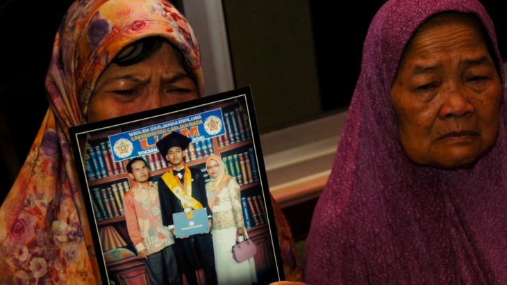 Mother shows a picture of her son, Agil Nugroho Septian, Lion Air flight JT610 passenger, at her house in Tegal