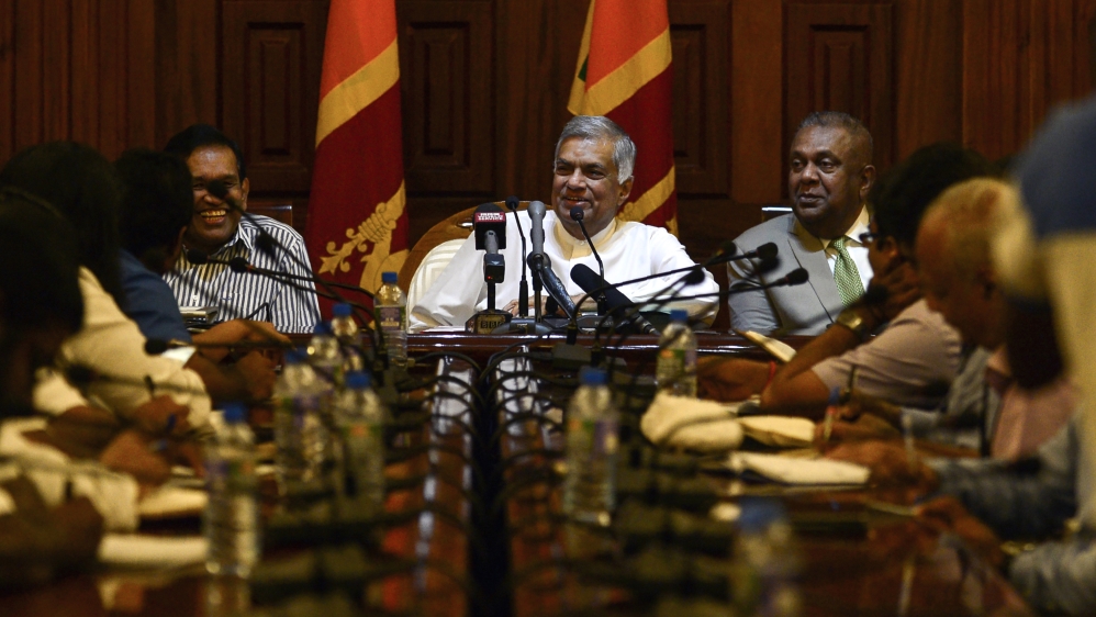 Ranil Wickremesinghe (centre) insists he remains the prime minister [Lakruwan Wanniarachchi/ AFP]