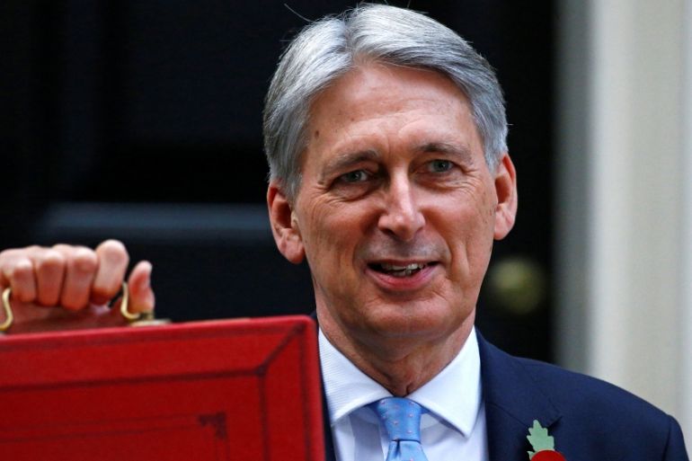 Britain''s Chancellor of the Exchequer Philip Hammond stands outside 11 Downing Street before he delivers his budget statement in the House of Commons in London