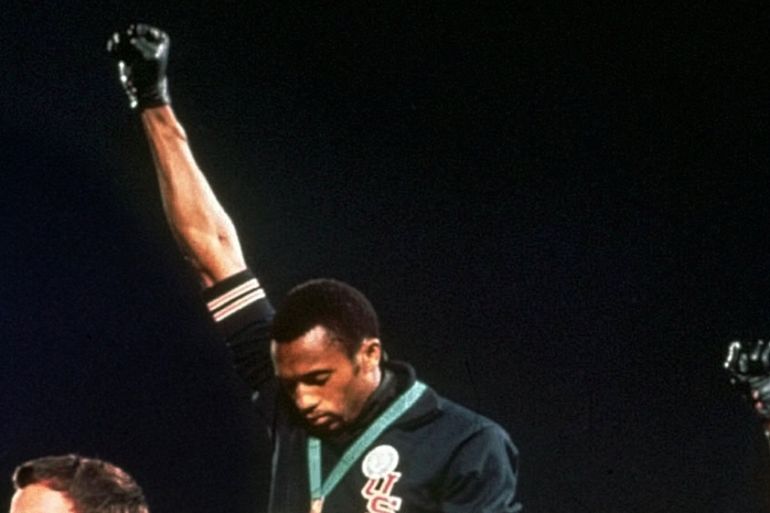 Australian silver medalist Peter Norman, left, stands on the podium as Americans Tommie Smith, centrr, and John Carlos raise their gloved fists in a human rights protest in 1968 [File: AP Photo]