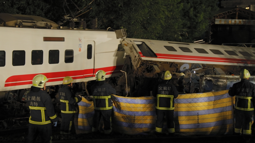  All of the train's eight carriages had derailed and five had flipped onto their side [Daniel Shih/ AFP]