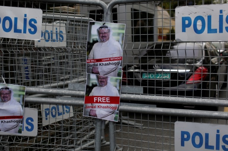 Pictures of Saudi journalist Khashoggi are placed on security barriers during a protest outside the Saudi Consulate in Istanbul