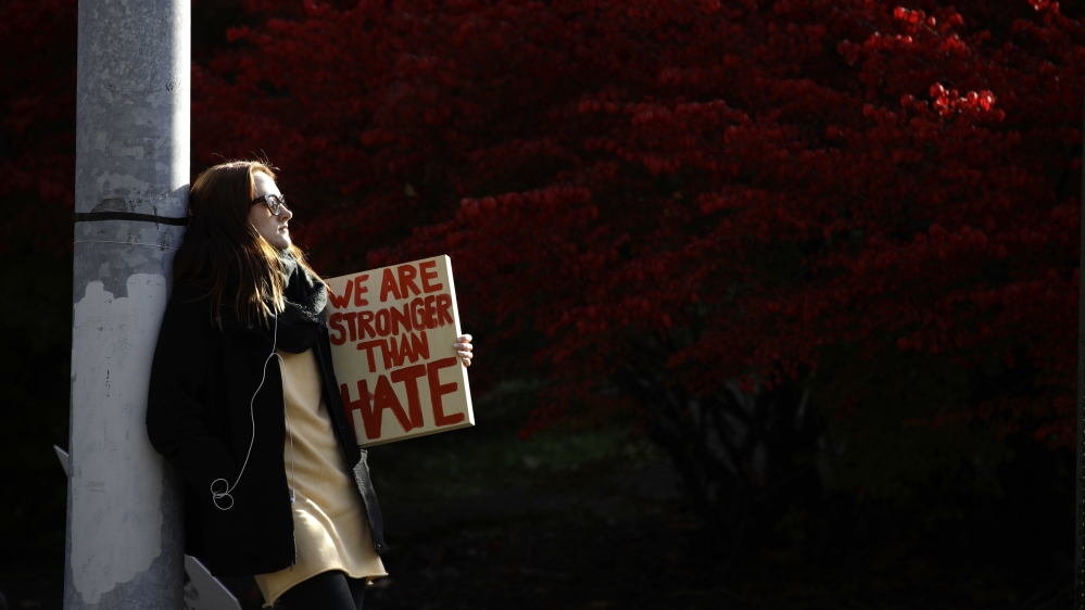 A demonstrator waits for the start of a protest in the aftermath of the mass shooting at the Tree of Life Synagogue [Matt Rourke/AP Photo]