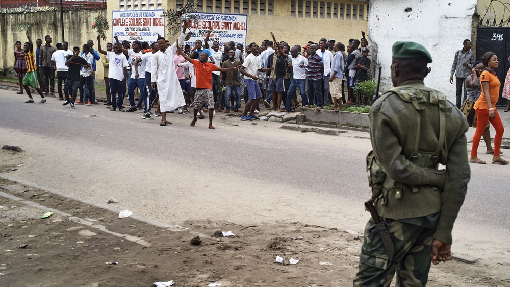 Protesters attempt to leave the safe haven of a church during violent protests that left five people dead and scores injured in Kinshasa in January 2018. The banned protest was against President Joseph Kabila after he stated that he would not step down at the end of his term in December 2018 [Robert Carrubba/EPA]