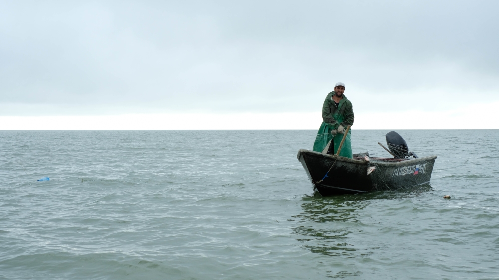 A fisherman at sea in his boat, or 'bayda' [Nikolay Korzhov/Al Jazeera]