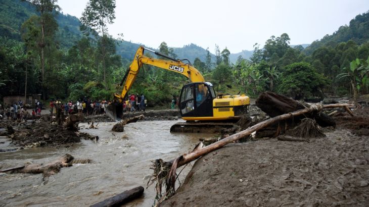 Rescuers work along Sume river in search for bodies of those killed after a landslide rolled down the slopes of Mt. Elgon through the Nanyinza village in Bududa district