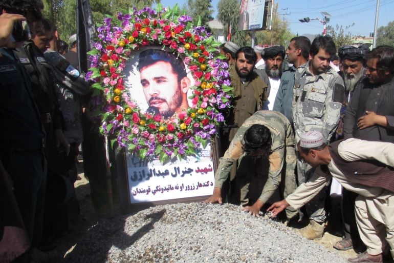 People attend a burial ceremony of General Abdul Razeq, the Kandahar police commander, who was killed in yesterday''s attack, in Kandahar province, Afghanistan