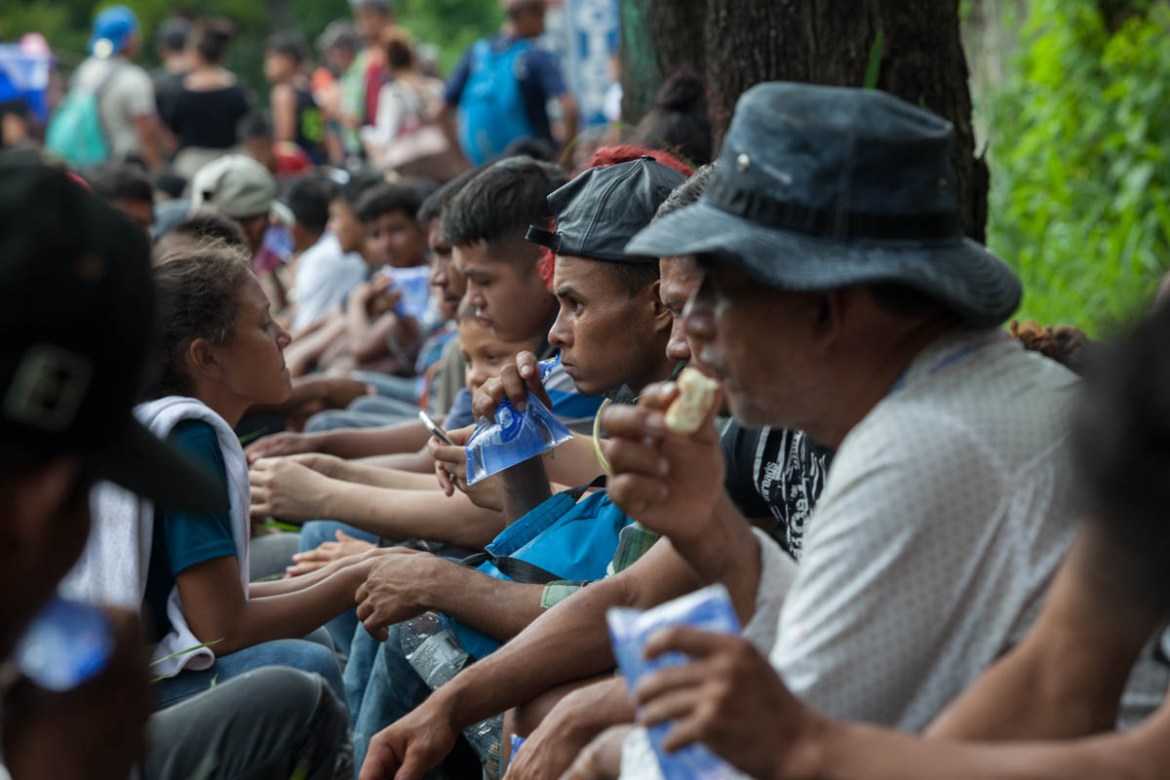 Honduran migrants and refugees rest along Route 18 after hours of walking down Route 18 towards Chiquimula October 21.