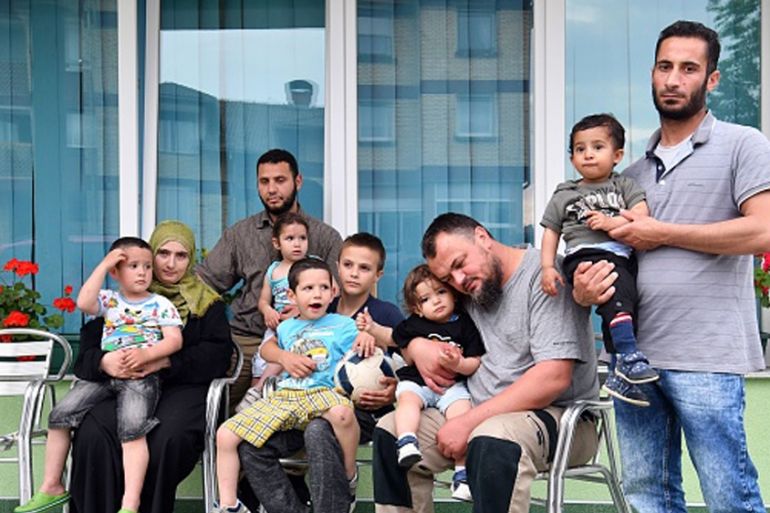 BOSNIA-BALKANS-MIGRANTS-POLITICS Bosnian Muslim, Emir Mustedanagic (46) (2nd R) poses with migrants in front of his house in the north-western Bosnian town of Velika Kladusa on May 10, 2018