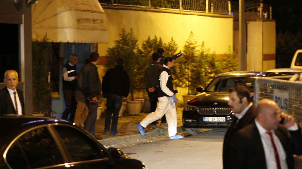 A Turkish police forensic officer exits the Saudi Arabia's Consulate in Istanbul on Monday [AP]