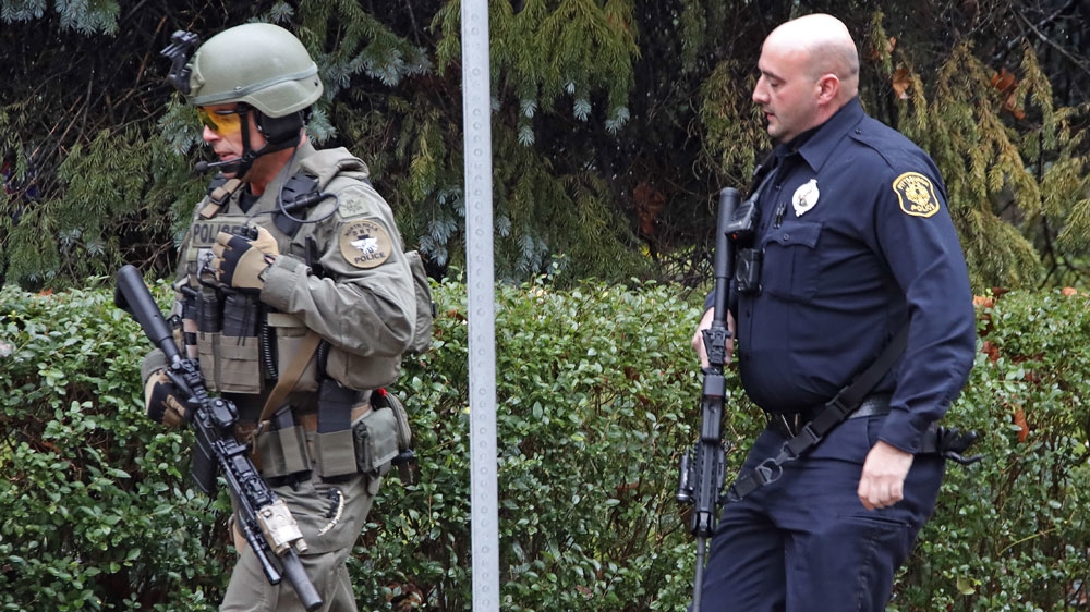 Local TV news footage showed police at the location with rifles [Gene J Puskar/AP]