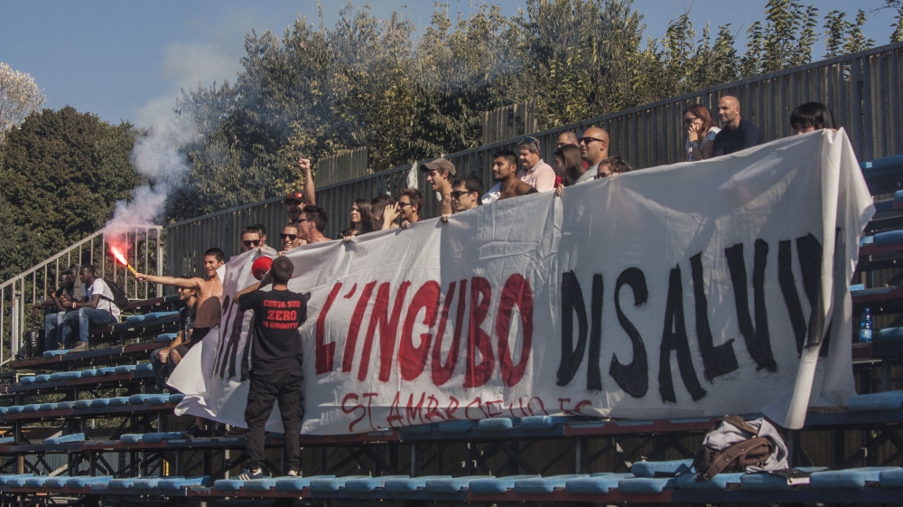 Italian fans support the new team – with antifascist slogans and a banner reading, 'We’re Salvini’s nightmare - St Ambroeus FC' [Alessio Perrone/Al Jazeera]