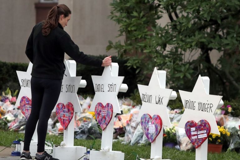 A woman reacts at a makeshift memorial outside the Tree of Life synagogue