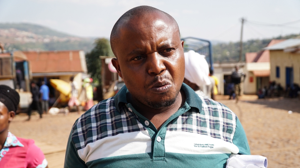 Bayingana Mark, a trader in Kigali, says that many have lost their livelihoods since the taxes on used clothes were implemented [Azad Essa/Al Jazeera]