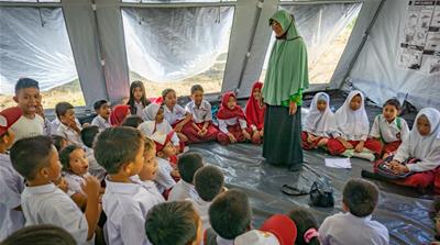 Children from Abdurrahman's school have lessons in a tent after the school building was destroyed in the Sulawesi disaster [Ian Morse/Al Jazeera]
