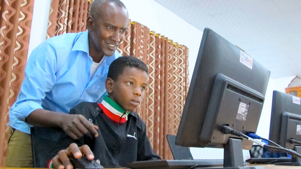 Ahmed Koki helps the younger generations navigate around the world in Murzuk, Libya [Karlos Zurutuza/Al Jazeera] 