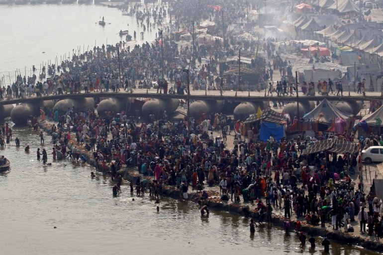Devotees take a holy dip at Sangam, the confluence of the Ganges, Yamuna and Saraswati rivers, during Magh Mela festival in Allahabad