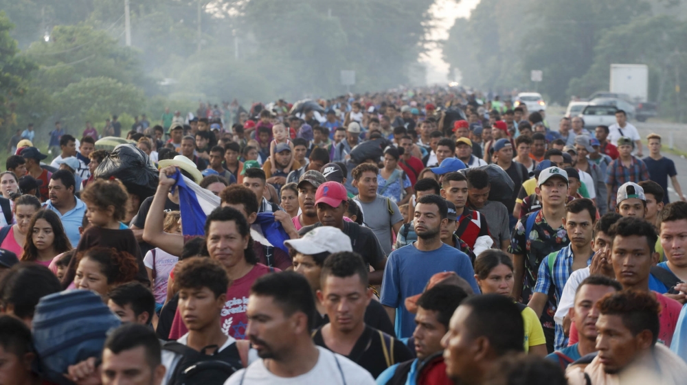 Central American migrants and refugees walking to the US start their day departing Ciudad Hidalgo, Mexico, on Sunday [Moises Castillo/AP Photo] 