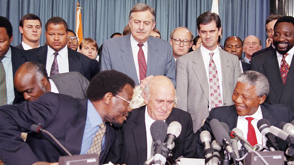 Botha (centre, standing) was minister of mineral energy affairs under Mandela [File: Lynne Sladky/The Associated Press]