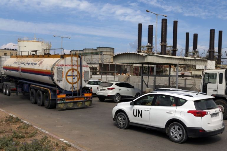 United Nations vehicle follows a fuel tanker as it arrives at the Gaza power plant, in the central Gaza Strip