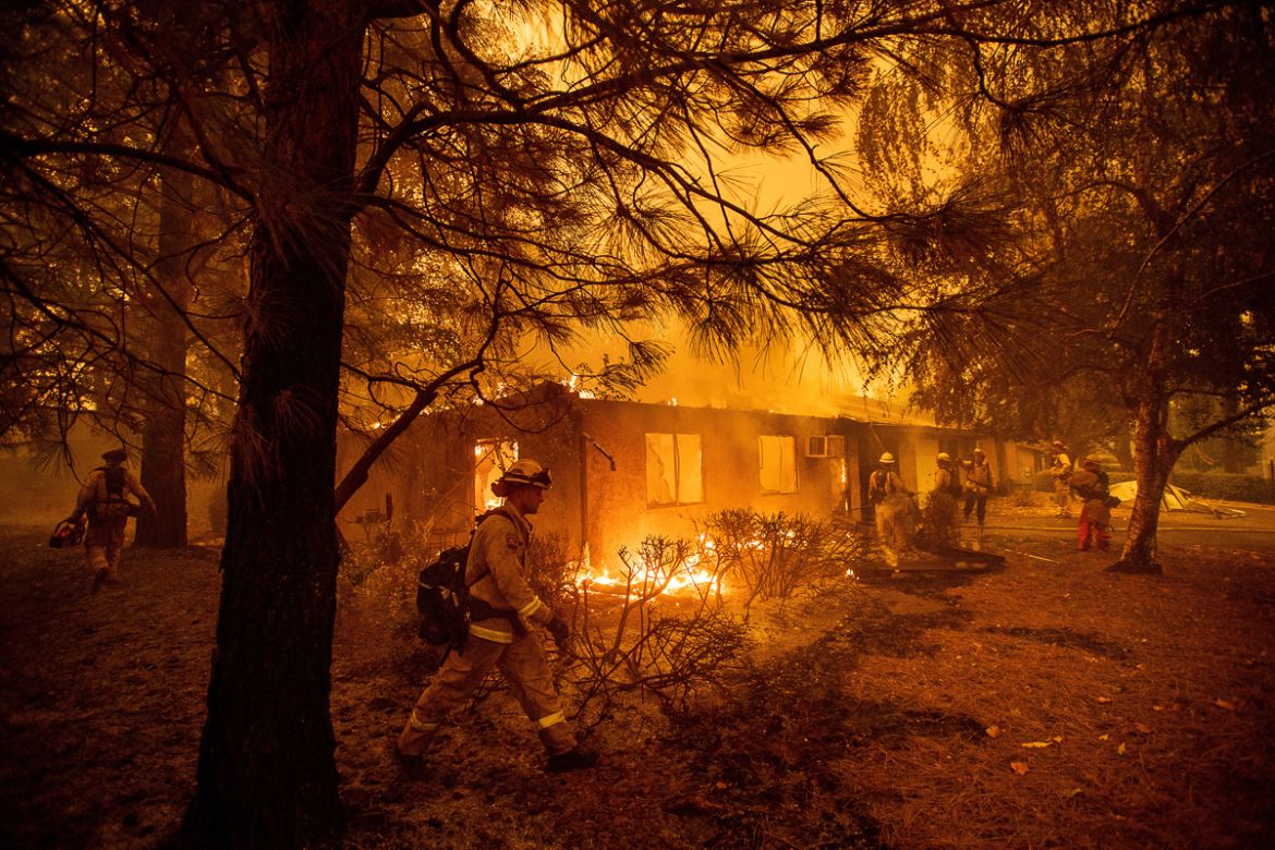 Firefighters work to keep flames from spreading through the Shadowbrook apartment complex as a wildfire burns through Paradise, Calif., on Friday, Nov. 9, 2018. (AP Photo/Noah Berger)