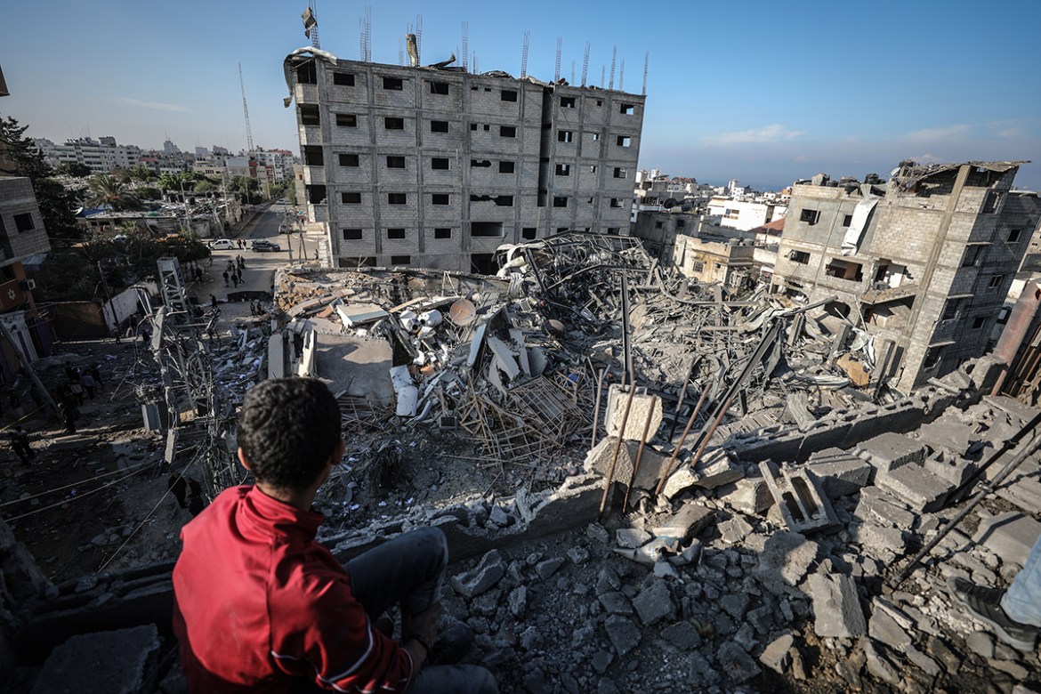 Palestinian boy inspects the rubble of the Al-Aqsa TV''s building after it was targeted by Israeli airstrikes against Gaza, in Gaza City on November 13, 2018. ( Ali Jadallah - Anadolu Agency )