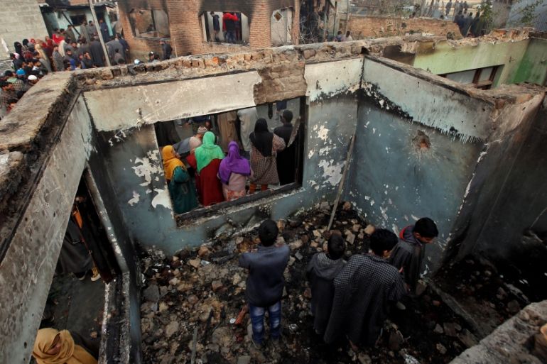 People inspect a house which according to local media