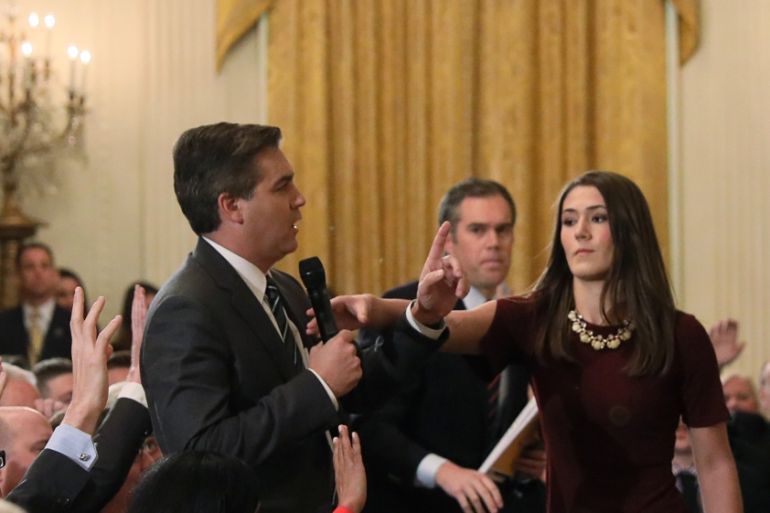 White House intern reaches for microphone held by CNN''s Acosta as he questions U.S. President Trump during news conference in Washington