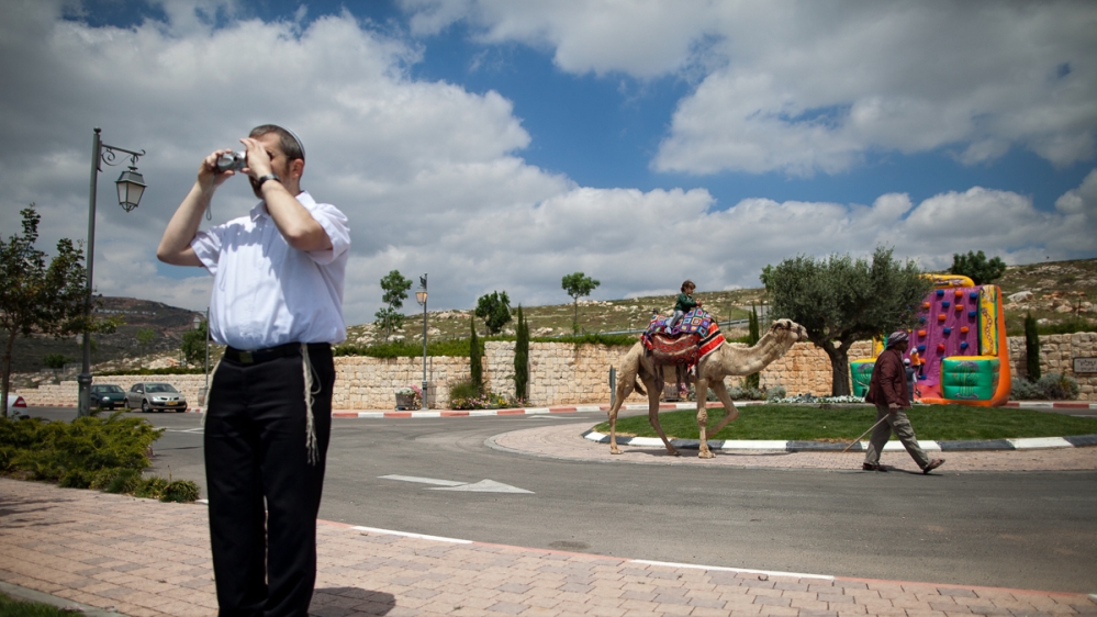 In this photo on April 20, 2011, Israelis visit the Nahalat Binyamin visitors centre near the Jewish West Bank settlement of Psagot, near Ramallah, during the Passover holiday [File: Oded Balilty/AP Photo]