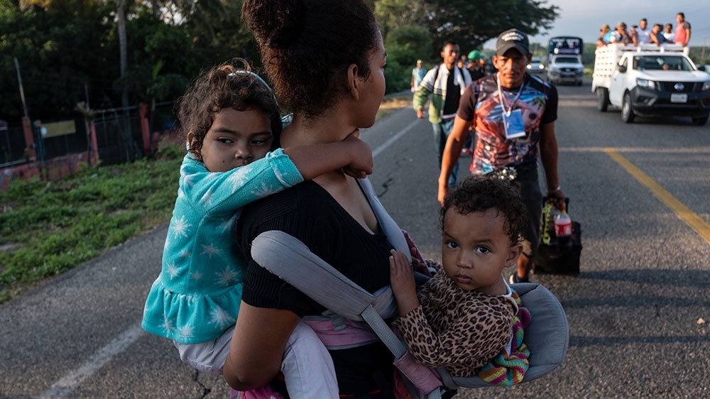 In this file photo taken on November 1, 2018 migrants and refugees heading to the US, walk along the road from La Ventosa to Matias Romero, Oaxaca State, Mexico [Guillermo Arias/AFP] 