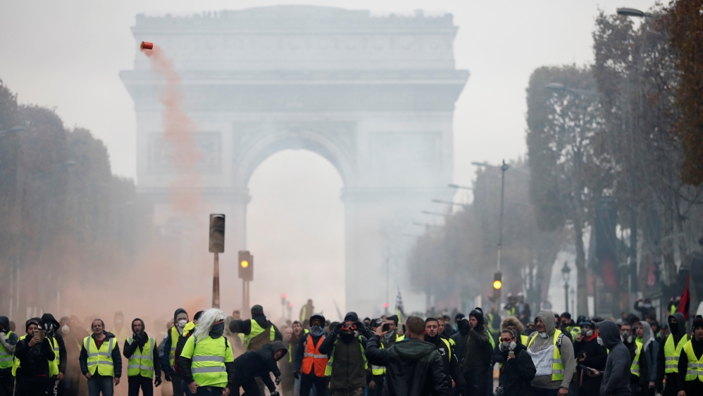 'Yellow vest' protesters block the Champs-Elysees in Paris on November 24 [Benoit Tessier/Reuters] 