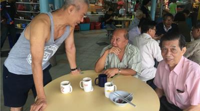KS Teng starts each weekday morning at a hawker centre in the island's Ang Mo Kio neighbourhood [Tom Benner/Al Jazeera]